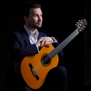 Ian Watt holding his guitar