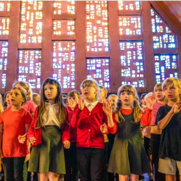 Primary aged children singing in a choir